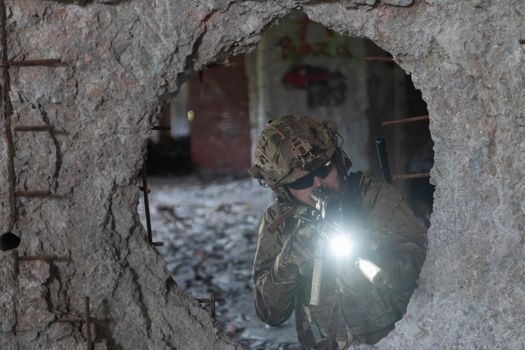 A bearded soldier in the uniform of special forces in dangerous military action in a dangerous enemy area. Selective focus. High-quality photo