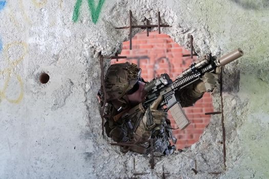 A bearded soldier in the uniform of special forces in dangerous military action in a dangerous enemy area. Selective focus. High-quality photo