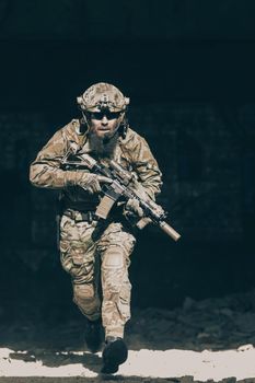 A bearded soldier in the uniform of special forces in dangerous military action in a dangerous enemy area. Selective focus. High-quality photo