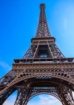 Eiffel Tower against blue sky with clouds in Paris, France. April 2019