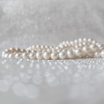 Nature white pearl beads on sparkling background