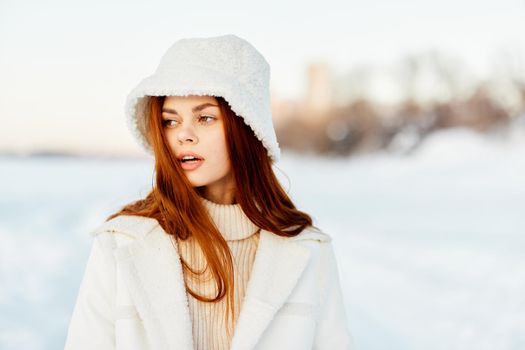 beautiful woman red hair snow field winter clothes Fresh air. High quality photo