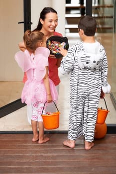 Two kids trick-or-treating on Halloween.