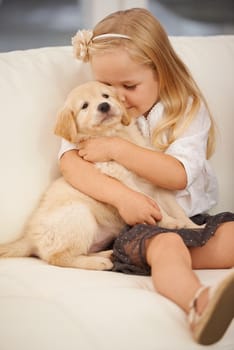 Cropped shot of a little girl holding a puppy.