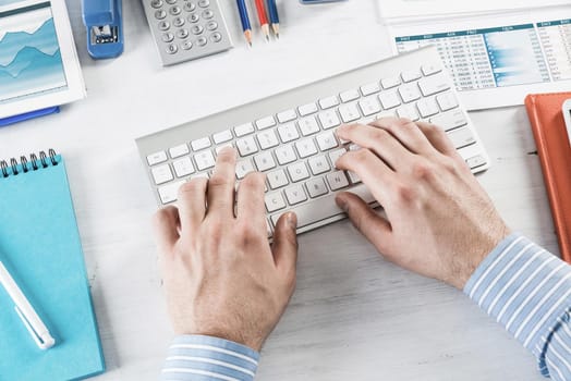 close-up men's hands type on the keyboard. office work