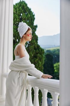 Woman in a bathrobe with patches on his face admires nature unaltered. High quality photo