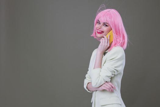 cheerful woman pink wig talking on the phone. High quality photo