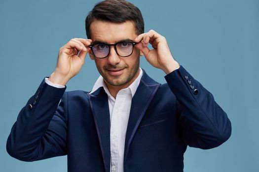 businessman portrait with glasses blue suit hand gestures emotions business and office concept. High quality photo