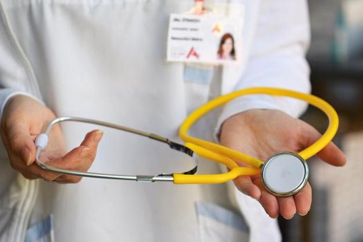 Female doctor holding a stethoscope. Concept for health and medicine. Hospital background.