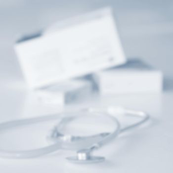 Stethoscope with medication on the table. Concept for health and medicine. Hospital background.