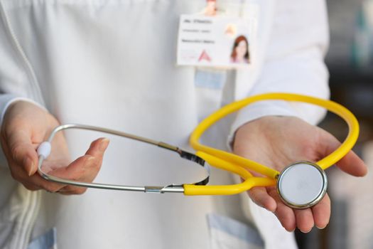 Female doctor holding a stethoscope. Concept for health and medicine. Hospital background.