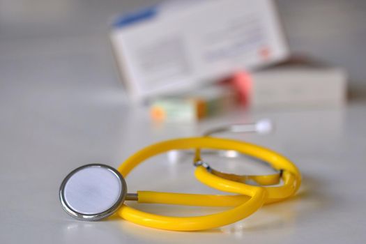 Stethoscope with medication on the table. Concept for health and medicine. Hospital background.