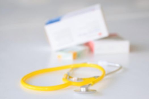 Stethoscope with medication on the table. Concept for health and medicine. Hospital background.