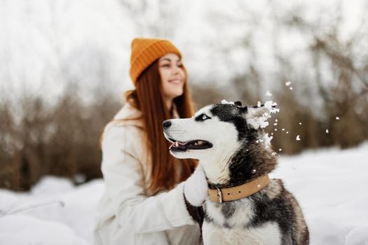 woman with a purebred dog outdoor games snow fun travel Lifestyle. High quality photo