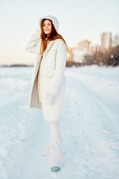 young woman in a white coat in a hat winter landscape walk Lifestyle. High quality photo