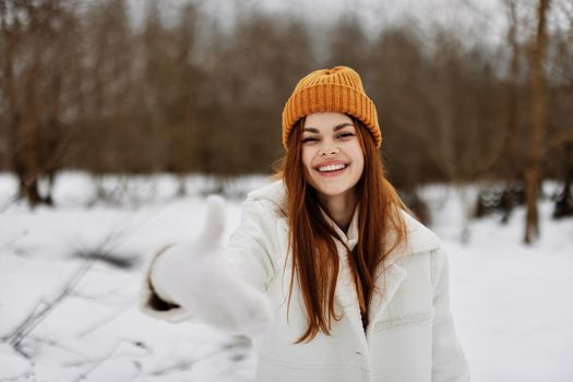 young woman red hair walk in the fresh winter air There is a lot of snow around. High quality photo