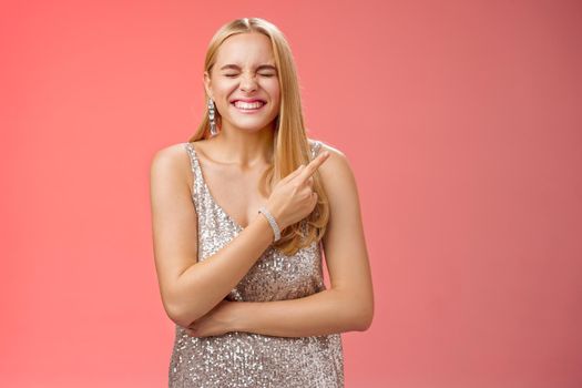 Lifestyle. Attractive excited happy charming blond girl attend luxurious party see famous person feel lucky amused close eyes grinning joyfully pointing delighted behind upper right corner enjoy event.