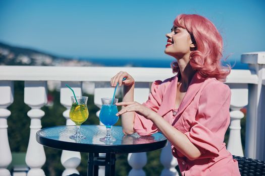 Delighted young girl enjoying a colorful cocktail hotel terrace Relaxation concept. High quality photo