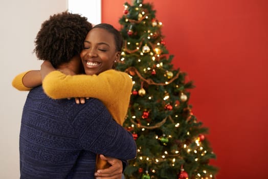 Shot of an affectionate young couple celebrating Christmas together.