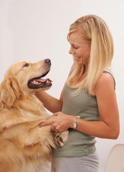 Shot of an attractive young woman interacting with her dog.