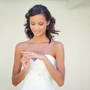 A young bride looking at her wedding ring.