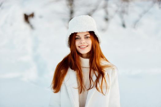 woman in a white coat in a hat winter landscape walk Lifestyle. High quality photo