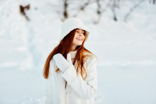 woman in a white coat in a hat winter landscape walk Lifestyle. High quality photo