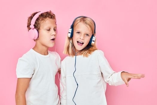 Funny children dancing with headphones entertainment isolated background. High quality photo