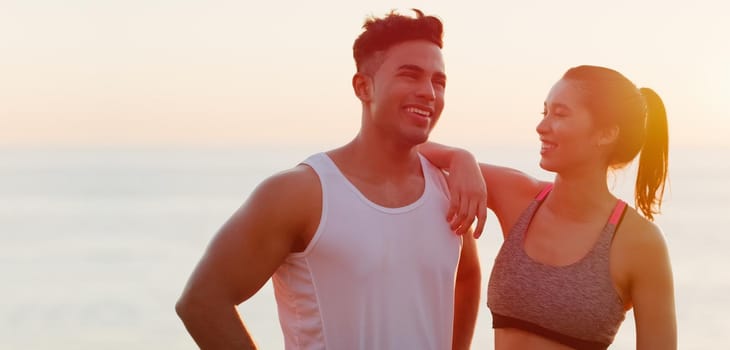 Cropped shot of an affectionate young couple looking happy while working out outdoors.