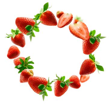 Lots of strawberries in the shape of a frame. Isolated on a white background.