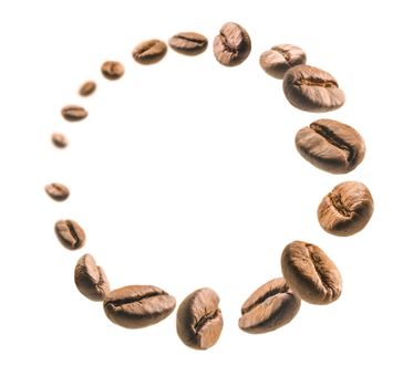 Coffee beans levitate on a white background.