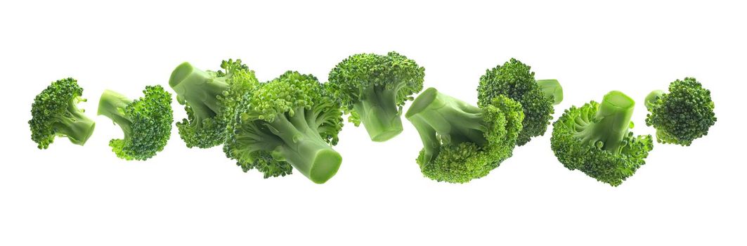 Green broccoli levitating on a white background.