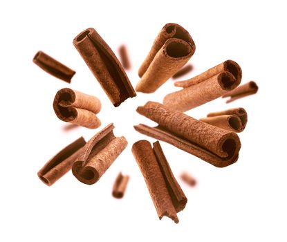 Cinnamon sticks levitate on a white background.