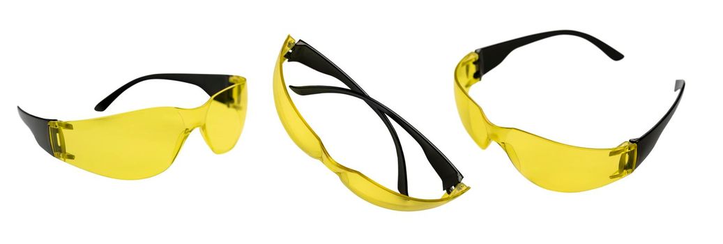 Yellow safety glasses in different angles on a white background.