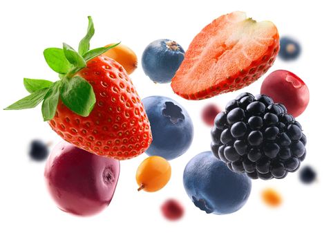 Many different berries in the form of a frame on a white background.