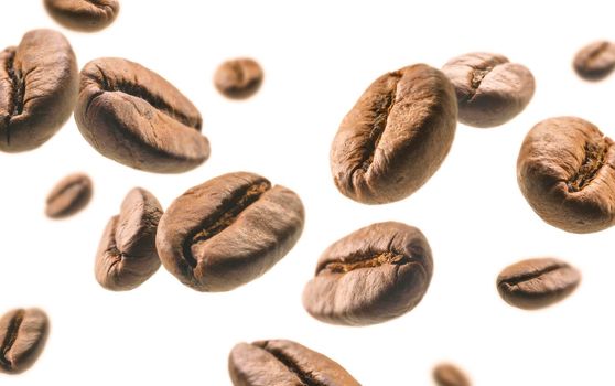 Coffee beans levitate on a white background.