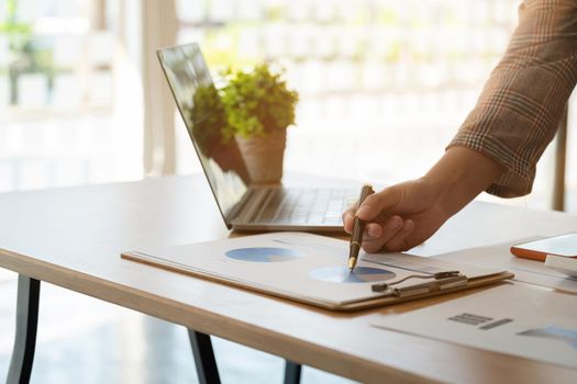 Financial Business woman analyze the graph of the company's performance to create profits and growth, Market research reports and income statistics, Financial and Accounting concept.