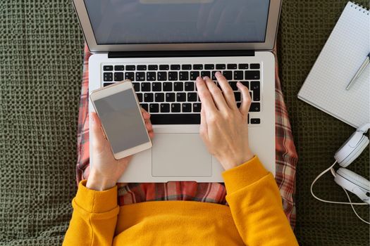 Online shopping, online learning, top view work at home. Distance education. Woman typing to blog on laptop. Freelancer, digital nomad concept