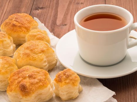 Delicious rolls from lush yeast-free puff pastry on parchment paper. Breakfast with a Cup of tea and homemade cakes in the morning.