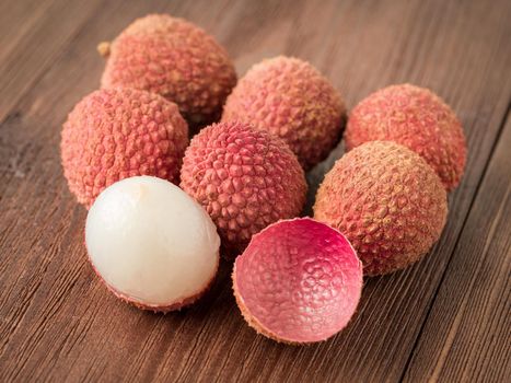 fresh ripe litchi fruit on a wooden table, macro, side view.