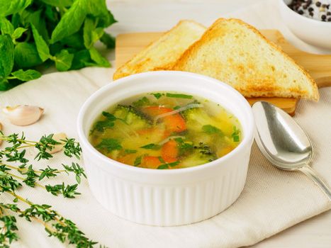 Delicious, thick Soup with mixed vegetables - cauliflower, broccoli, carrots, potatoes, garlic, tomatoes. Healthy diet food. Close-up, side view