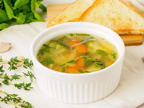 Delicious, thick Soup with mixed vegetables - cauliflower, broccoli, carrots, potatoes, garlic, tomatoes. Healthy diet food. Close-up, side view