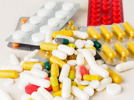 handful of scattered medicines, pills and tablets on white background