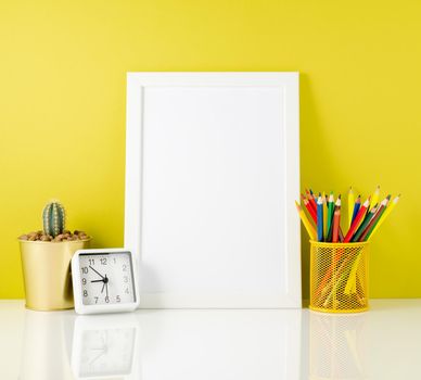 Mockup with clean white frame, colored pencils on bright yellow background. Concept for creativity, drawing.