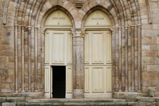 Old symmetrical Ivory catholic doors of a church