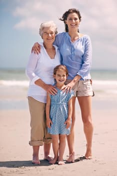 Portrait of a woman with her daughter and mother at the beach.