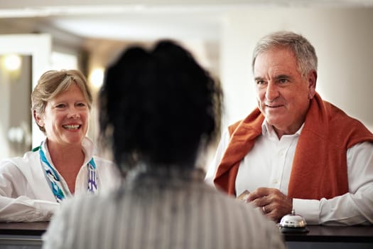 Cropped shot of a senior couple checking in at the hotel.