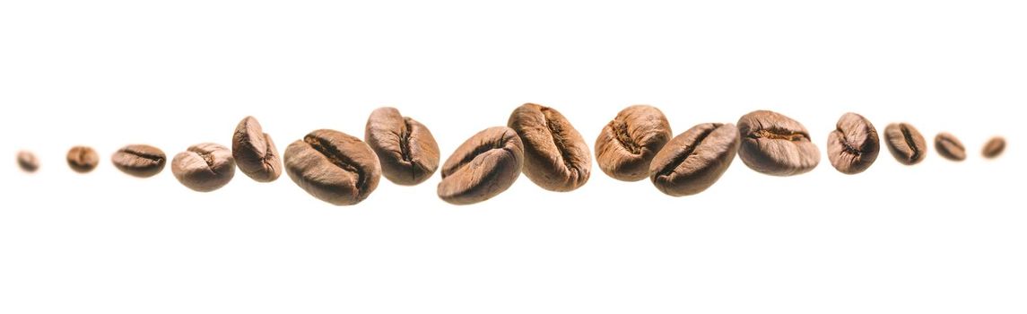 Coffee beans levitate on a white background.