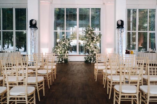 A place for a wedding ceremony in the interior. Decorated wedding venue.