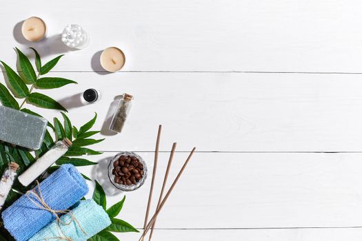 Spa set with towels and soap on white wooden background top view. Copy space. Still life. flat lay